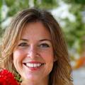 Smiling woman Jennifer, 51, enjoying a vibrant, healthy meal outdoors